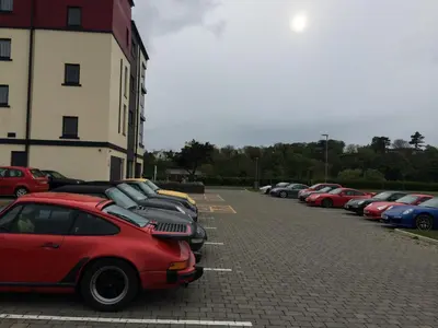 a row of cars parked in a parking lot at Ramsey Park Hotel in Ramsey