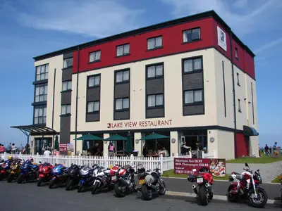 a row of motorcycles parked in front of a building at Ramsey Park Hotel in Ramsey