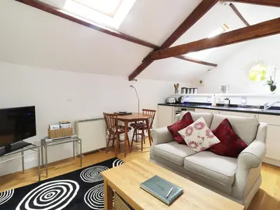 a living room with a couch and a table at Holemire Barn in Cockermouth