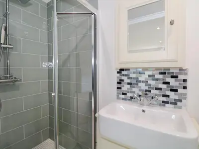 a bathroom with a sink and a shower at Coney Garth Retreat in Beckermet