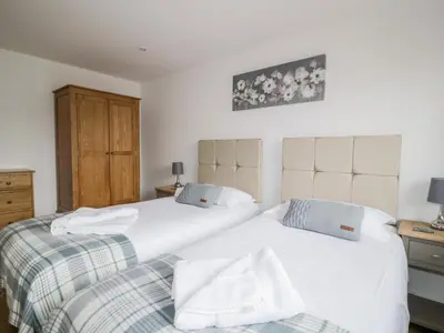 two beds sitting next to each other in a bedroom at Coney Garth Retreat in Beckermet