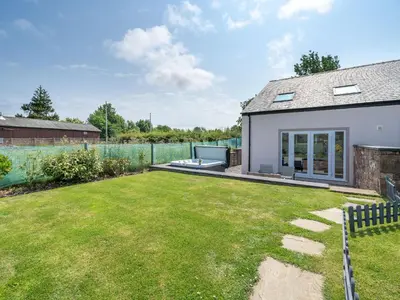 a house with a garden and a fence at Coney Garth Retreat in Beckermet