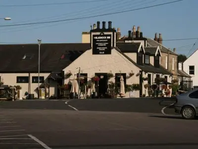 a car parked in front of a building with a sign at The Bladnoch Inn in Bladnoch