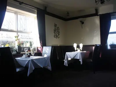 two tables in a restaurant with white table cloth at The Bladnoch Inn in Bladnoch