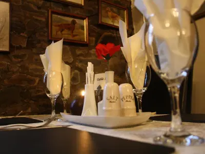 a table with a table cloth with wine glasses on it at The Bladnoch Inn in Bladnoch
