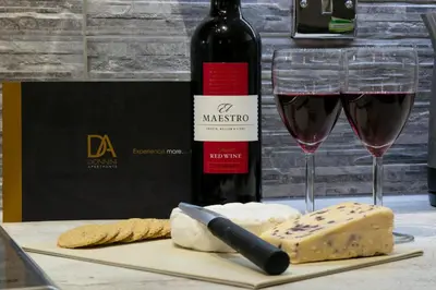 a bottle of wine and a glass of wine and cheese at Forbes Retreat - Donnini Apartments in Ayr