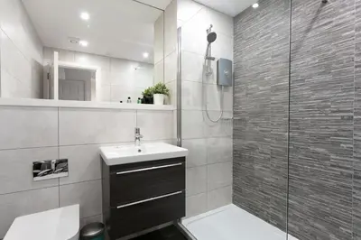 a bathroom with a shower and a sink and a toilet at Forbes Retreat - Donnini Apartments in Ayr