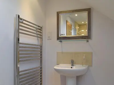 a bathroom with a sink and a mirror at Swallow Barn in Torpenhow