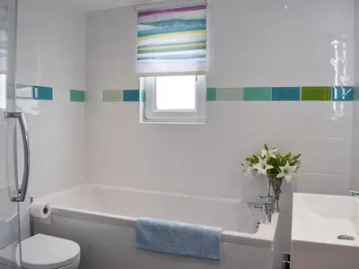 a bathroom with a tub and a toilet and a sink at Otterbield in Keswick