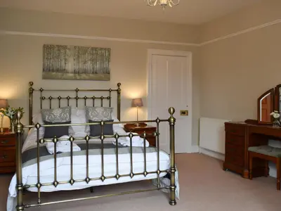 a bedroom with a bed and a desk and a dresser at Otterbield in Keswick