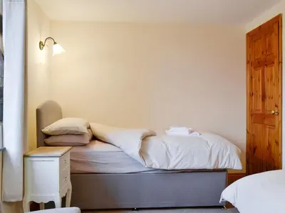 a bedroom with a bed with a nightstand and a bed sidx sidx sidx sidx at Doddick Chase Cottage - Uk1363 in Threlkeld