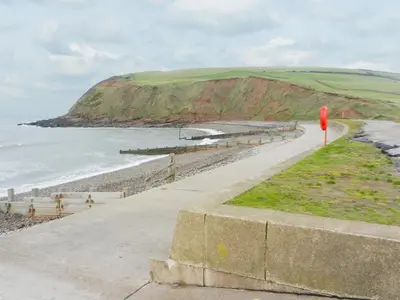 a path next to a beach with a red pole at The Byres Tethera in St Bees