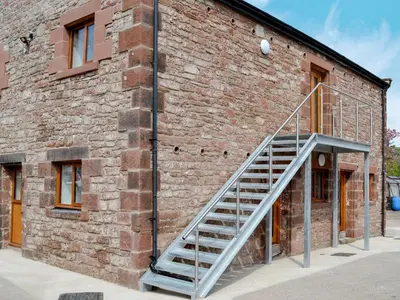 a staircase on the side of a brick building at The Byres Tethera in St Bees