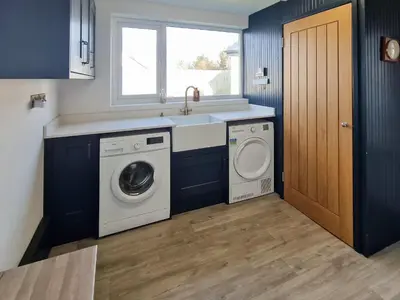 a kitchen with a sink and a washing machine at Gullsway in Glencaple