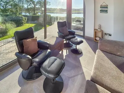 a waiting room with three chairs and a couch at Gullsway in Glencaple