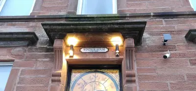 a clock on the side of a brick building at Windsor house in Stranraer
