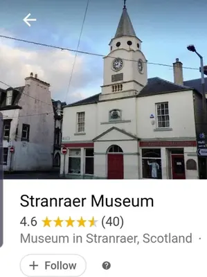 a building with a tower with a clock on it at Windsor house in Stranraer