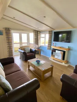 a living room with a couch and a coffee table at Limestone Lodges in Bothel