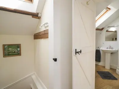 a bathroom with a white door and a sink at Swallows Nest in Carlisle