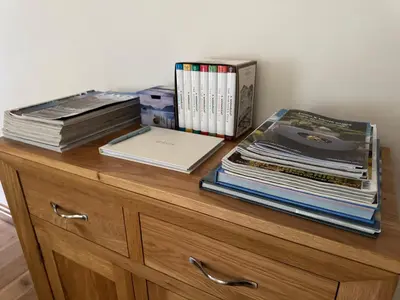 a pile of books sitting on top of a dresser at The Haven in Keswick