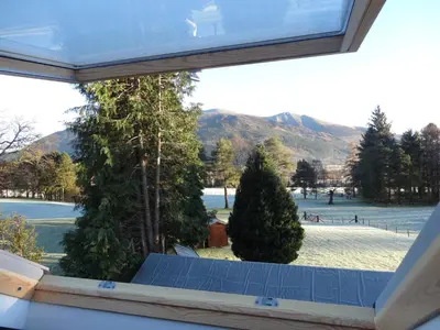 a window with a view of trees and a field at The Haven in Keswick