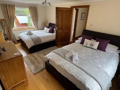 a bedroom with two beds and a window at The Haven in Keswick