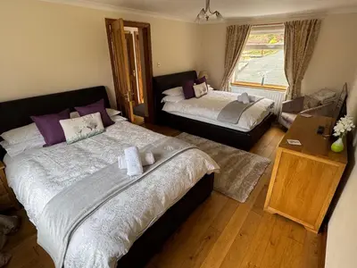 a bedroom with two beds and a window at The Haven in Keswick