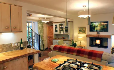 a living room with a couch and a table at Romantic Quirky Cottage with private garden and parking in Beckermet