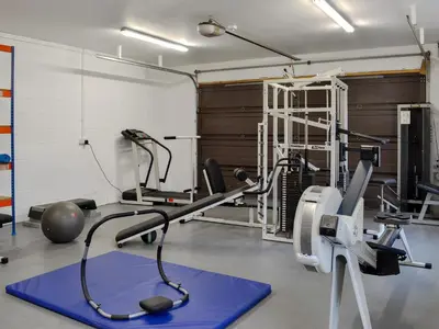 a gym with a treadmill and a exercise bike at Hawthorn Cottage in Stranraer