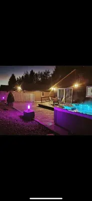 a pool with purple lights in a yard at night at Woodburn Lodges in Dumfries