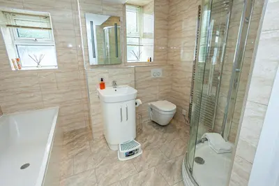 a bathroom with a toilet and a sink and a shower at Carlton 2 a large modern Keswick appt with parking in Keswick