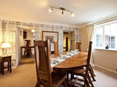 a dining room with a wooden table and chairs at Littlebeck Warren in Whitehaven