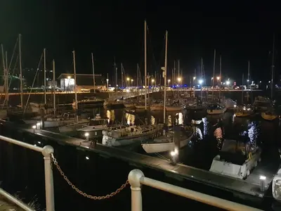a group of boats docked in a marina at night at Harbourside Apartment in Whitehaven