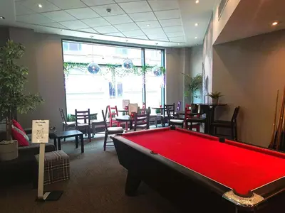 a pool table in a room with tables and chairs at ibis Carlisle City Centre in Carlisle