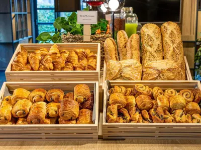 a display of bread and pastries in trays in a bakery at ibis Carlisle City Centre in Carlisle
