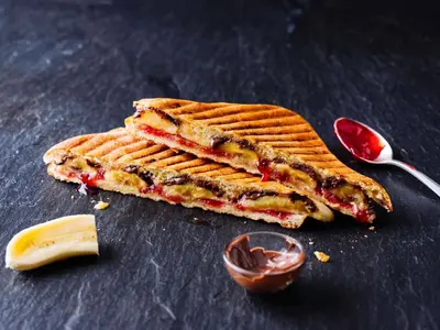 a waffle sandwich on a table with a spoon at ibis Carlisle City Centre in Carlisle