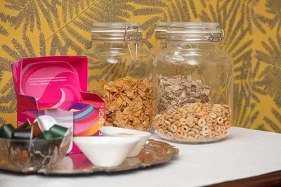 a table with two jars of nuts and other food items at Maxwelston Farmhouse in Girvan