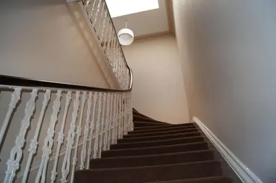 a staircase in a building with a light on the ceiling at Ayr Beach View Apartment in Ayr