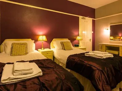 a hotel room with two beds with towels on them at Craglands Guest House in Keswick