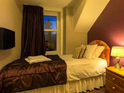 a bedroom with a bed and a window at Craglands Guest House in Keswick