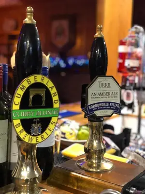 two bottles of beer sitting on a counter at The Mary Mount Hotel in Keswick