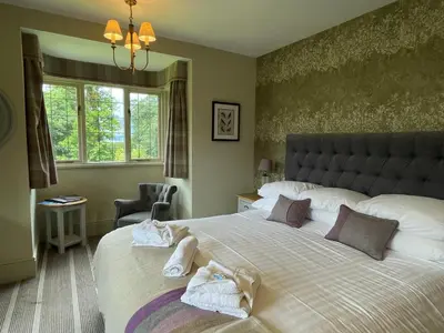a bedroom with a large bed with towels on it at The Mary Mount Hotel in Keswick