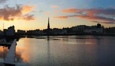 a view of a city with a river at sunset at The Mariners in Ayr