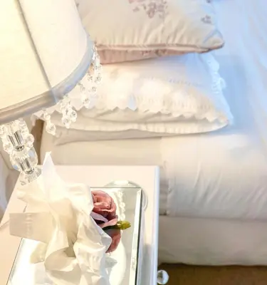 a tray with a bouquet of flowers next to a bed at Bessiestown Country Guesthouse in Carlisle