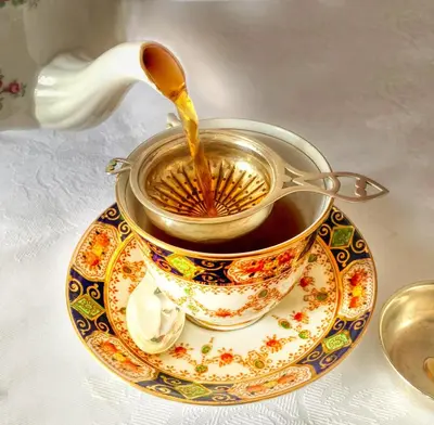 a pot of tea is being poured into a cup at Bessiestown Country Guesthouse in Carlisle