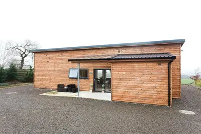 a small brick building with a glass door at Galloway View in Castle Douglas