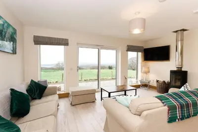 a living room with a couch and a table at Galloway View in Castle Douglas