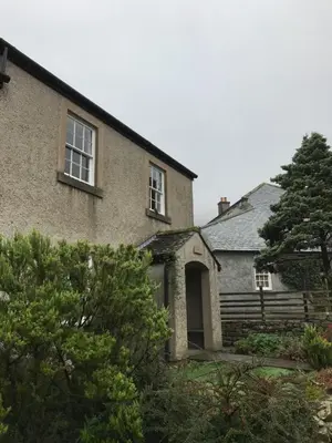 an old brick house with a tree in front of it at Scafell View Apartment, Wasdale, Lake District, Cumbria in Nether Wasdale