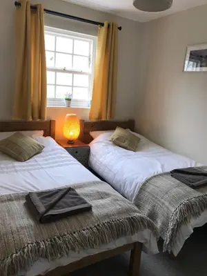 two beds in a room with a window at Scafell View Apartment, Wasdale, Lake District, Cumbria in Nether Wasdale