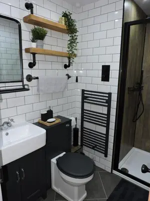 a bathroom with a black toilet and a sink at Scafell View Apartment, Wasdale, Lake District, Cumbria in Nether Wasdale